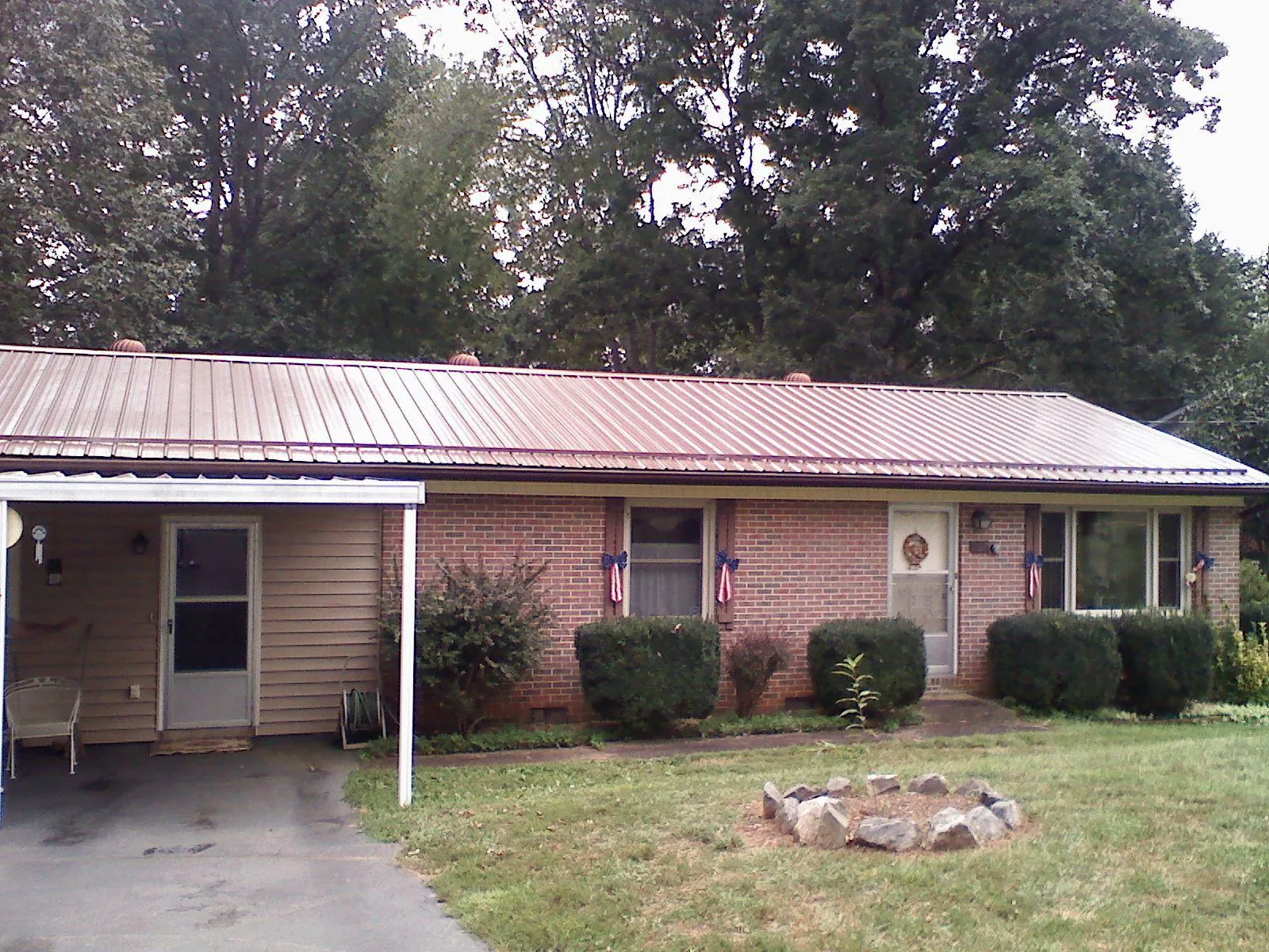 Bronze metal roof and carport on a brick ranch home — Roof Repair work by our crew in Mount Vernon